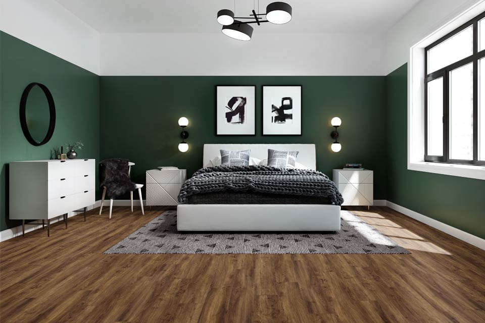 wood look flooring in living room with black and white furniture and green walls.